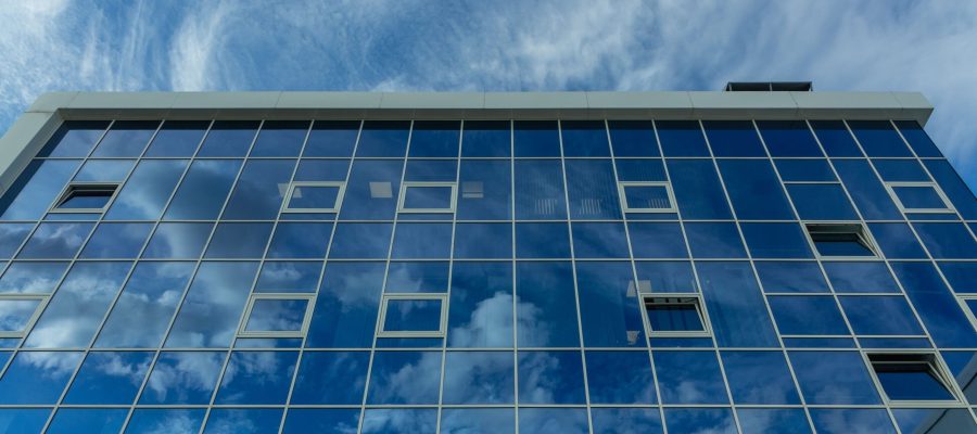 architectural-detail-facade-with-multiple-reflections-cloudy-sky-sun-exterior-modern-building-architecture-abstract-background (1)
